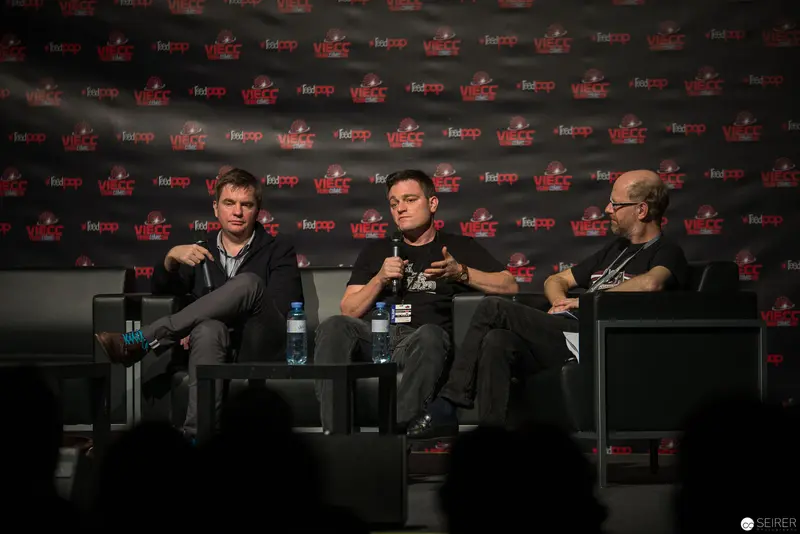 Panel Discussion at Fan Convention with Three Male Speakers