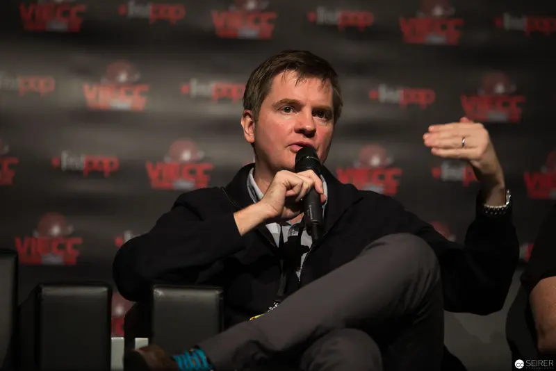 Presenter Speaking at VRWC Conference, Gesturing Emphatically During Panel Discussion