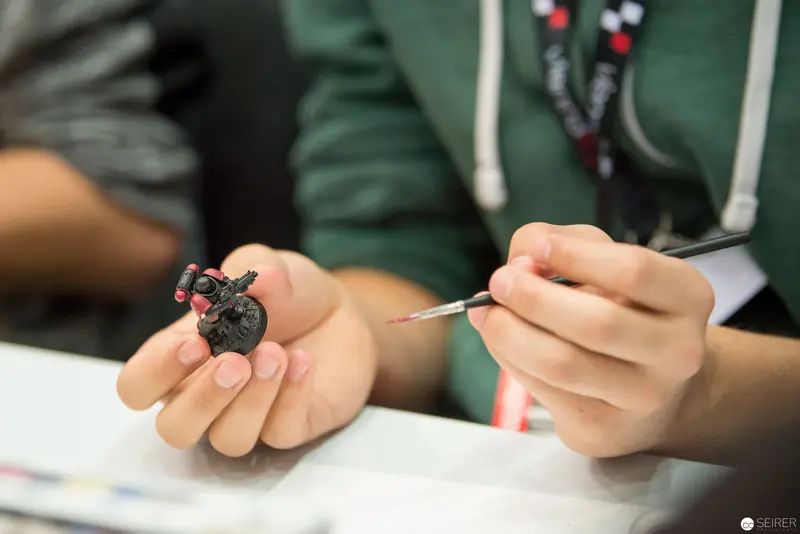 Miniature Painting Technique: Careful Brushwork on Small-Scale Figurine