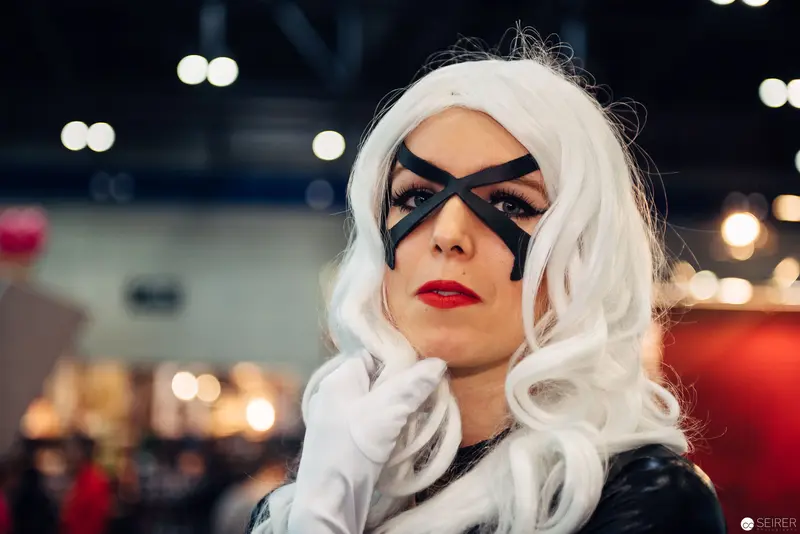 Cosplay Performance of Comic Book Character in White Wig and Black Mask