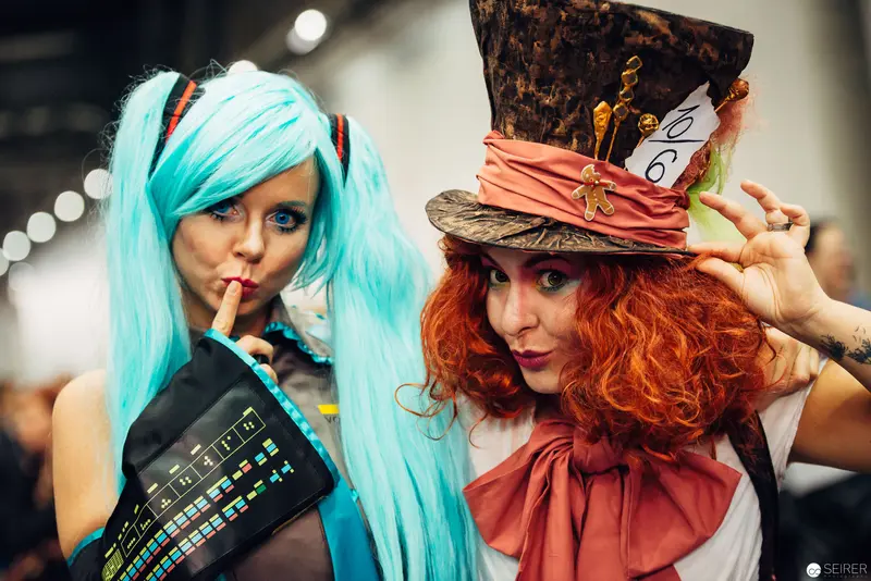 Cosplay Duo: Blue-Haired Anime Character and Steampunk Mad Hatter