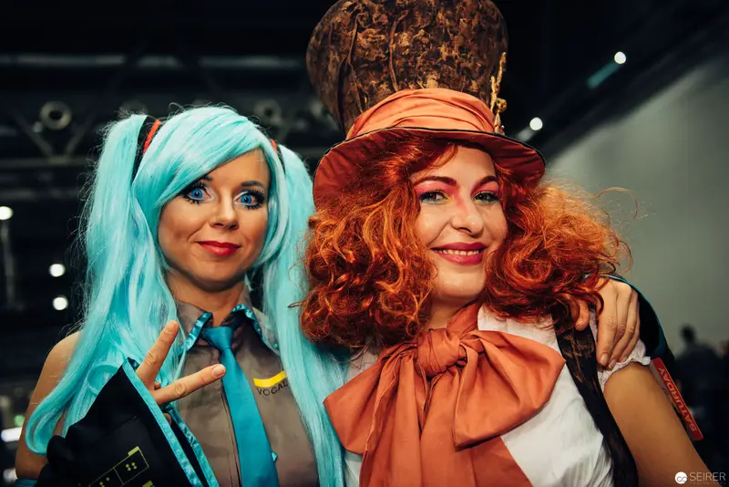 Two Costumed Performers in Vibrant Wigs at Convention or Cosplay Event