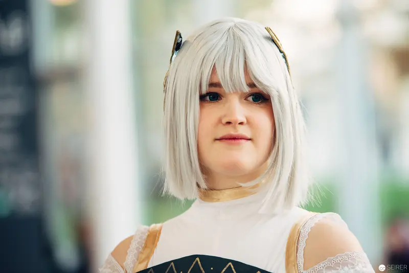 Young Woman in White Blonde Wig with Decorative Hair Accessories
