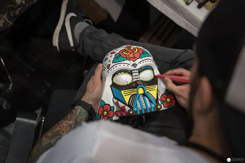 Artist Detailing Sugar Skull in Traditional Day of the Dead Style
