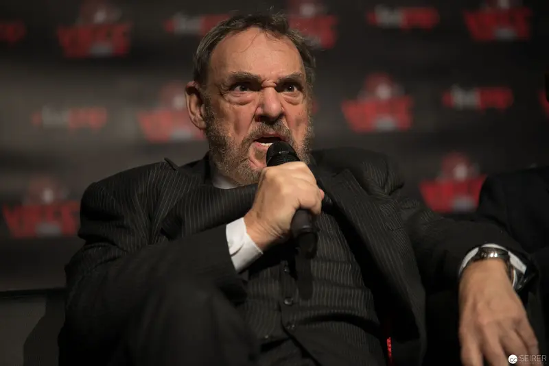 Intense Speaker Gesturing Emphatically During Press Conference or Event