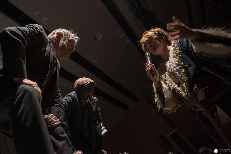 Dramatic Stage Confrontation with Performers in Stark Lighting