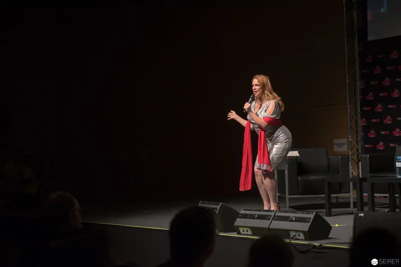 Woman Performer Delivers Passionate Monologue on Dimly Illuminated Stage