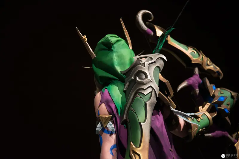 Ornate Fantasy Character Figurine with Green Hood and Elaborate Metallic Armor