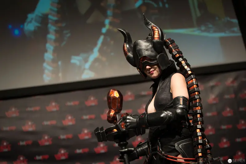 Costumed Performer with Horned Helmet and Technological Accessory at Event