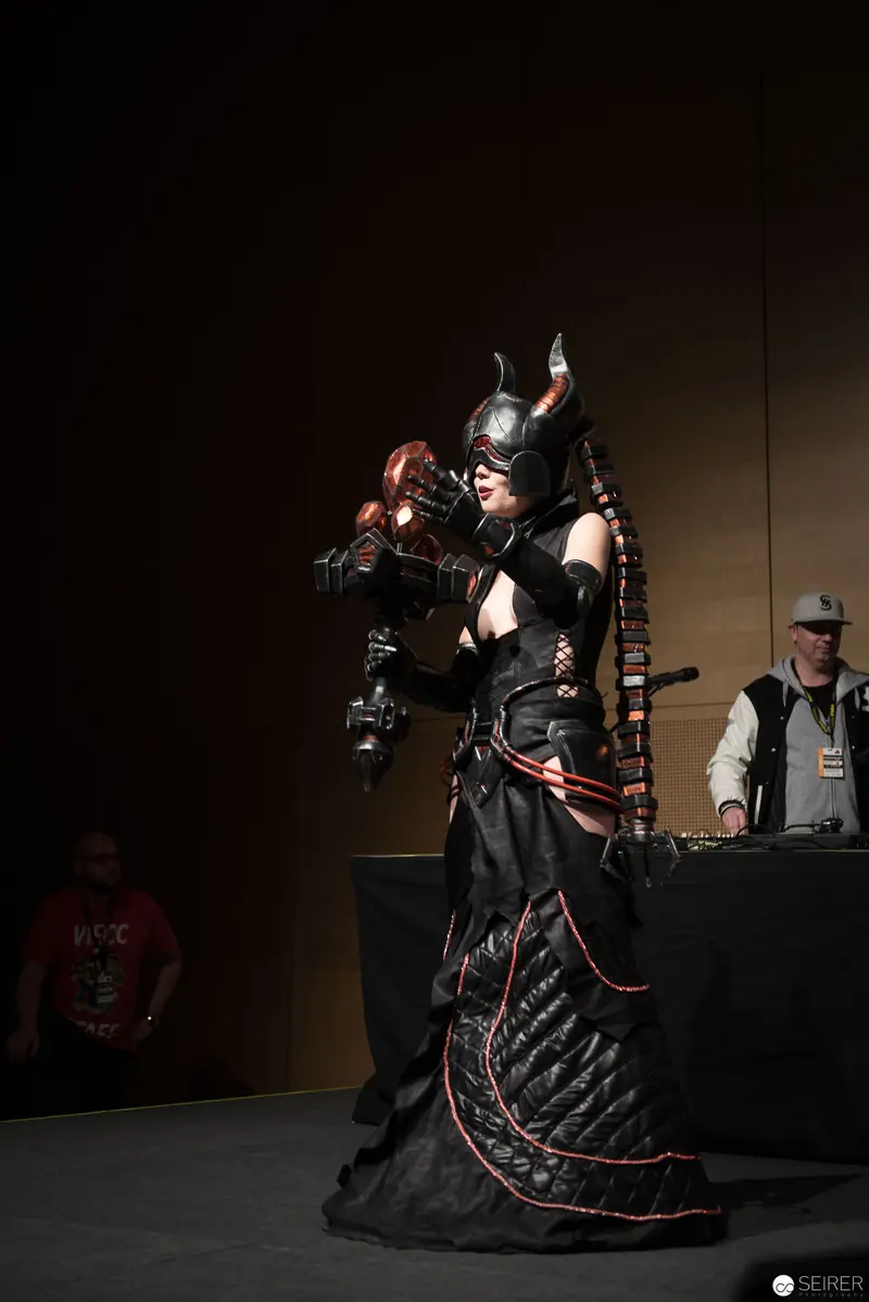 Elaborate Costumed Performer in Dark Dramatic Stage Costume with Horned Helmet
