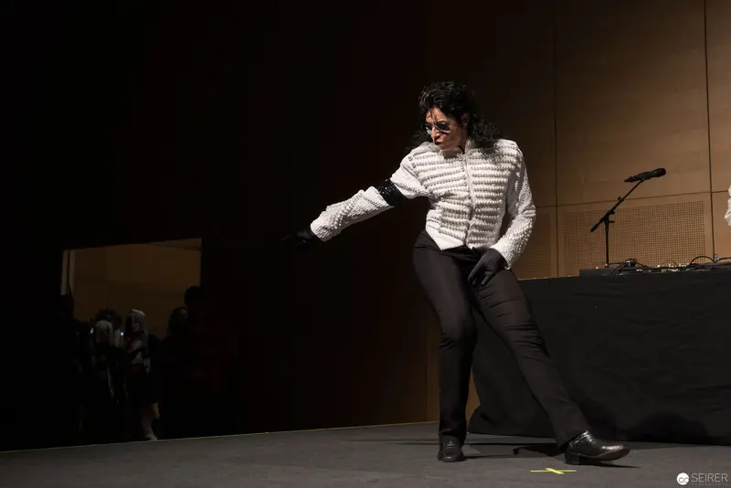 Performance Gesture in White Jacket: Dramatic Stage Pose