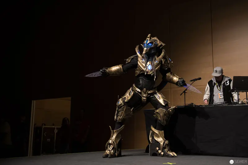 Costumed Performer in Metallic Armor Striking Dramatic Pose on Stage