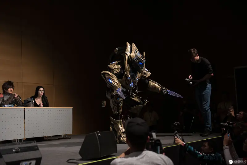 Costumed Performer in Robotic Armor on Stage at Public Event