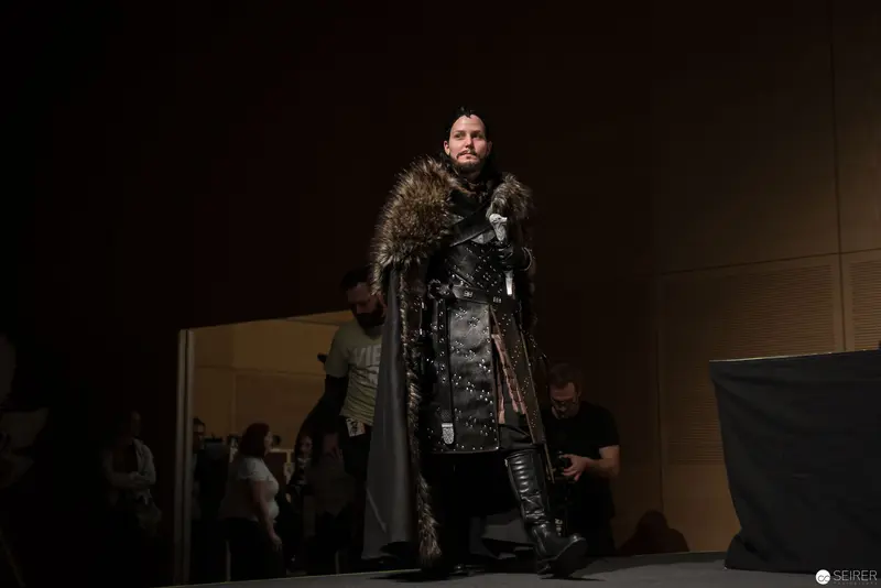 Medieval Costumed Figure in Dark Dramatic Stage Lighting