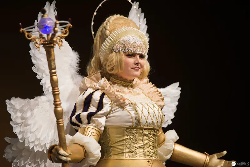 Baroque-Inspired Angel Cosplay with Ornate Costume and Luminescent Staff