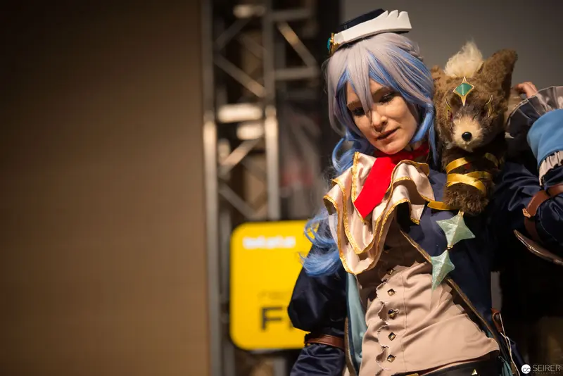 Cosplay Performance with Blue-Haired Character and Plush Companion