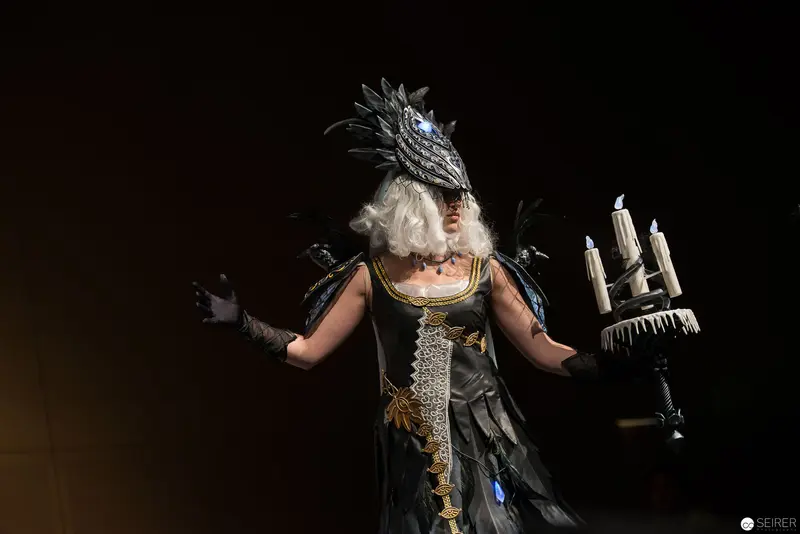 Theatrical Performance with Elaborate Feathered Mask and Candelabra Costume