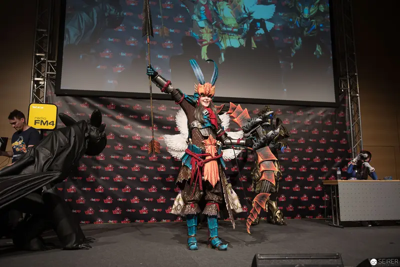 Costumed Performer in Elaborate Armor Posing at Fan Convention Cosplay Event
