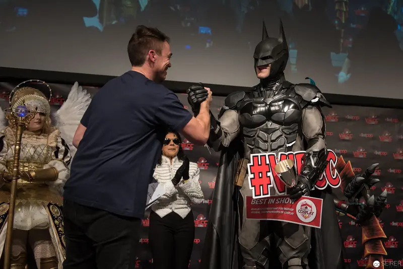 Batman Cosplayer Interacts with Fan at Comic Convention Stage