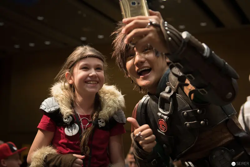 Costumed Young Fans Sharing Joyful Moment at Fan Convention