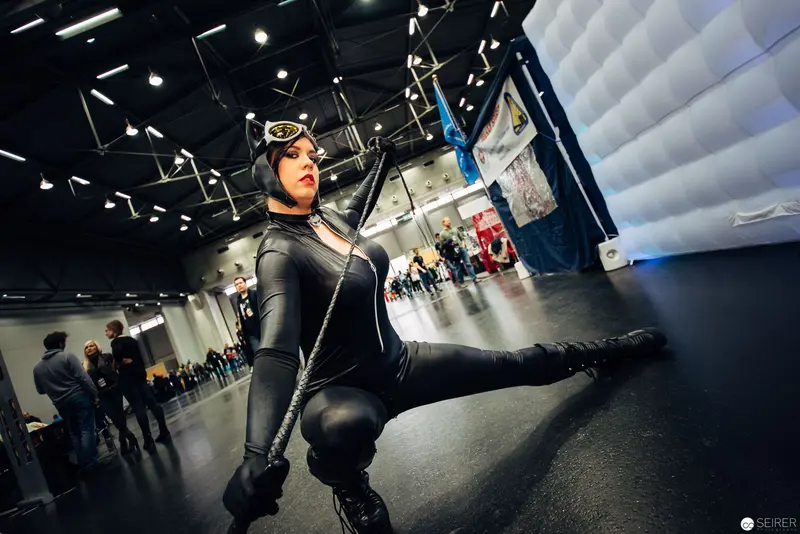 Cosplayer in Dynamic Pose at Convention Performance Space