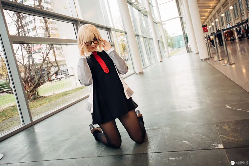 Cosplay Model in Black Uniform and Red Tie Posing by Glass Corridor Window