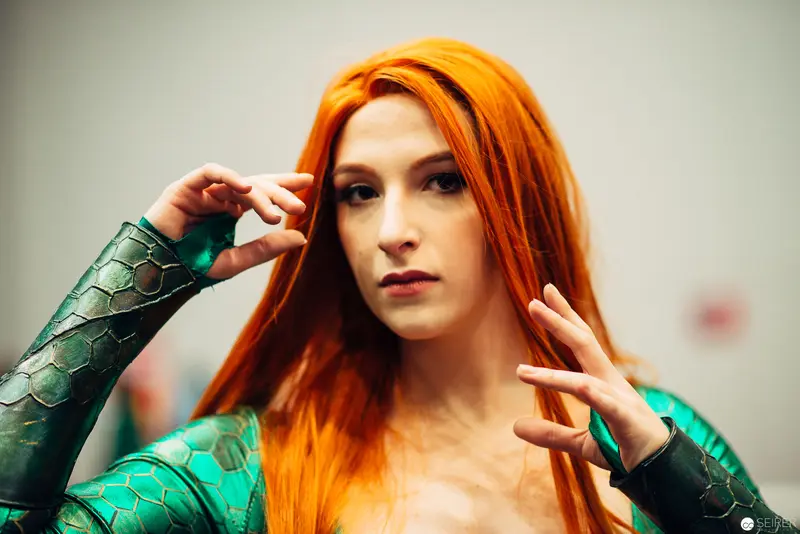 Cosplay Portrait with Vibrant Orange Hair in Metallic Green Armor