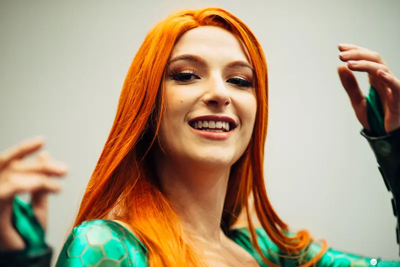 Vibrant Portrait of Woman with Bright Orange Hair in Turquoise Patterned Attire