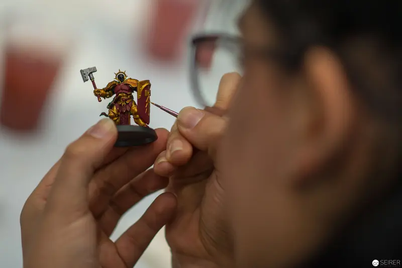 Miniature Figurine Painting: Delicate Craftsmanship in Close-Up Detail