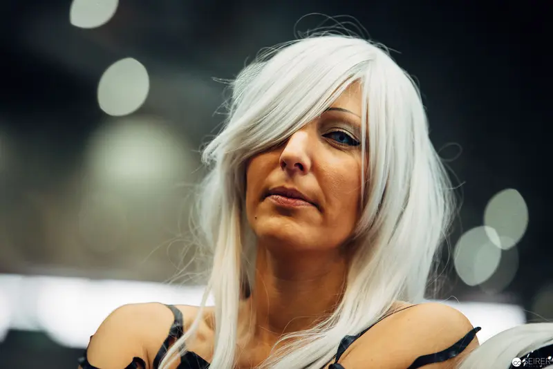 Platinum Blonde Woman with Dramatic Lighting and Soft Bokeh Background
