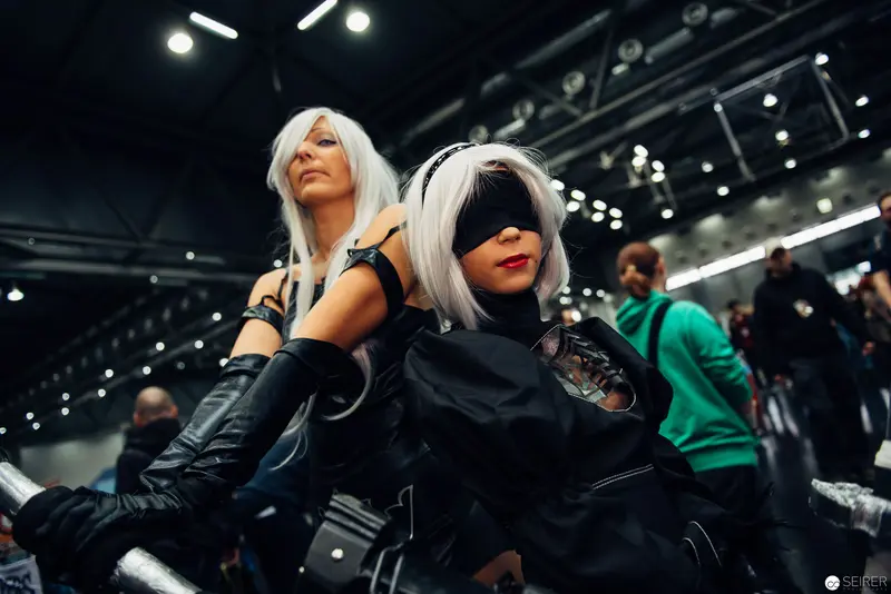 Cosplay Duo in Silver-White Wigs at Convention Performance Stage