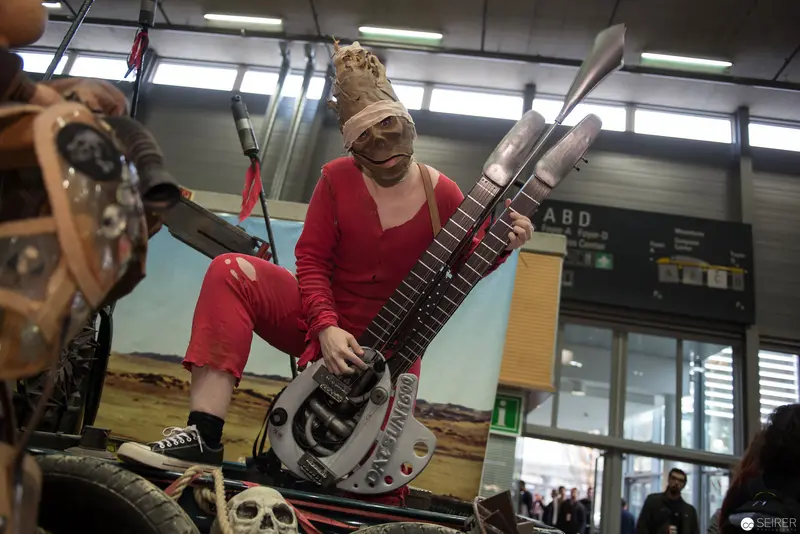Performer in Red with Elaborately Constructed Sculptural Musical Instrument