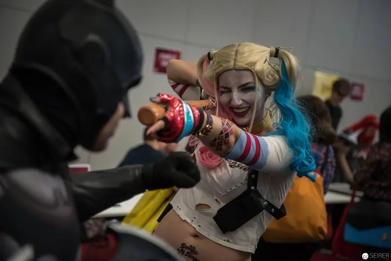 Comic Con Cosplay: Harley Quinn and Dark Antagonist in Dynamic Pose
