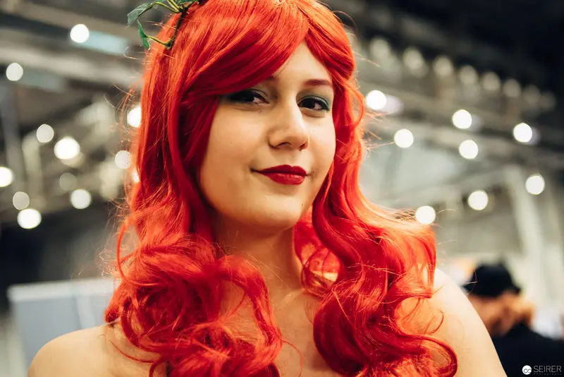 Vibrant Cosplay Portrait with Bright Red Curled Hair at Convention Event