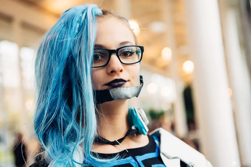 Blue-Haired Subject with Taped Mouth in Contemporary Urban Setting
