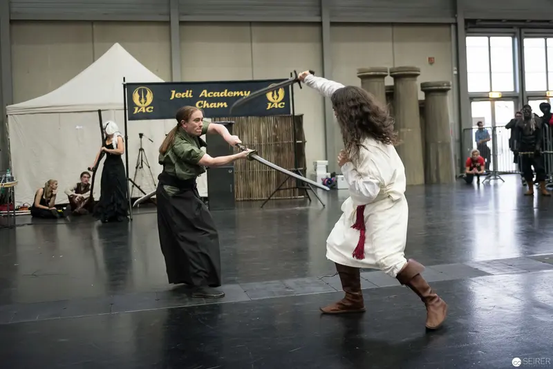 Jedi Academy Lightsaber Training: Two Performers in Stylized Combat Stance