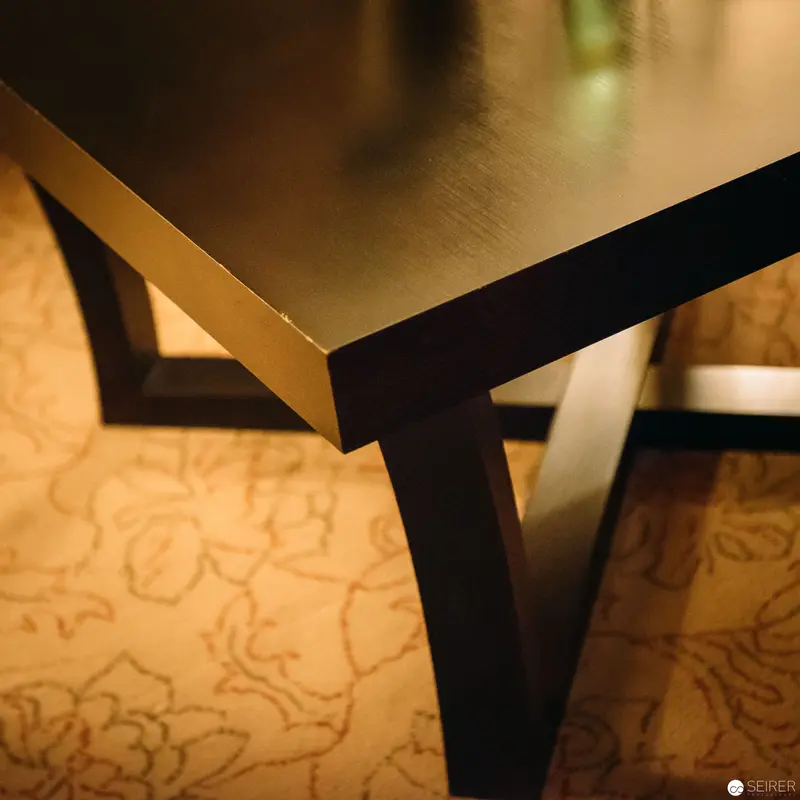 Geometric Table Corner Amid Ornate Floral Patterned Background