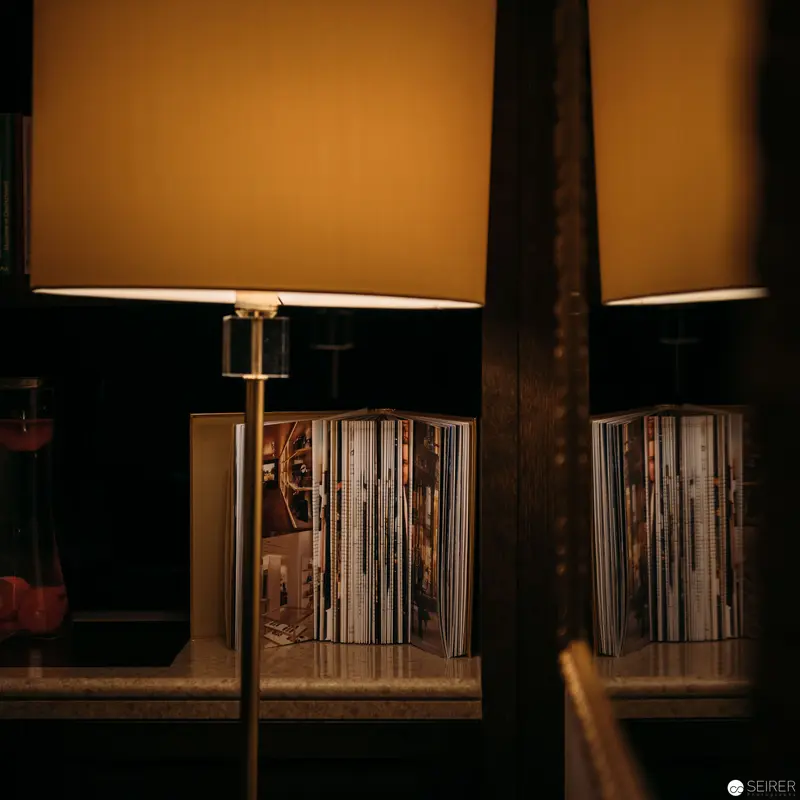 Illuminated Vintage Record Collection Framed by Warm Lamp Light