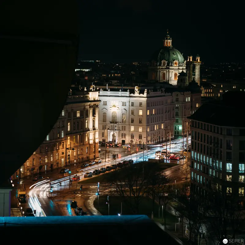 Night Illumination of Karlskirche and Historic Vienna Streetscape with Light Trails