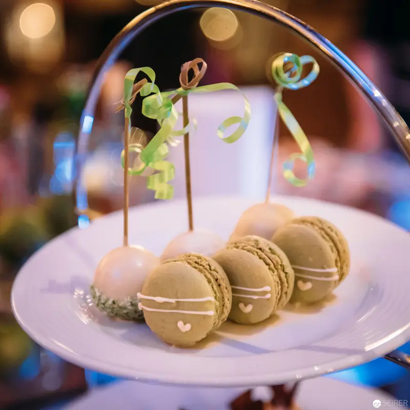 Elegant Pastel Macarons with Decorative Wire Sculpture on Fine China Plate