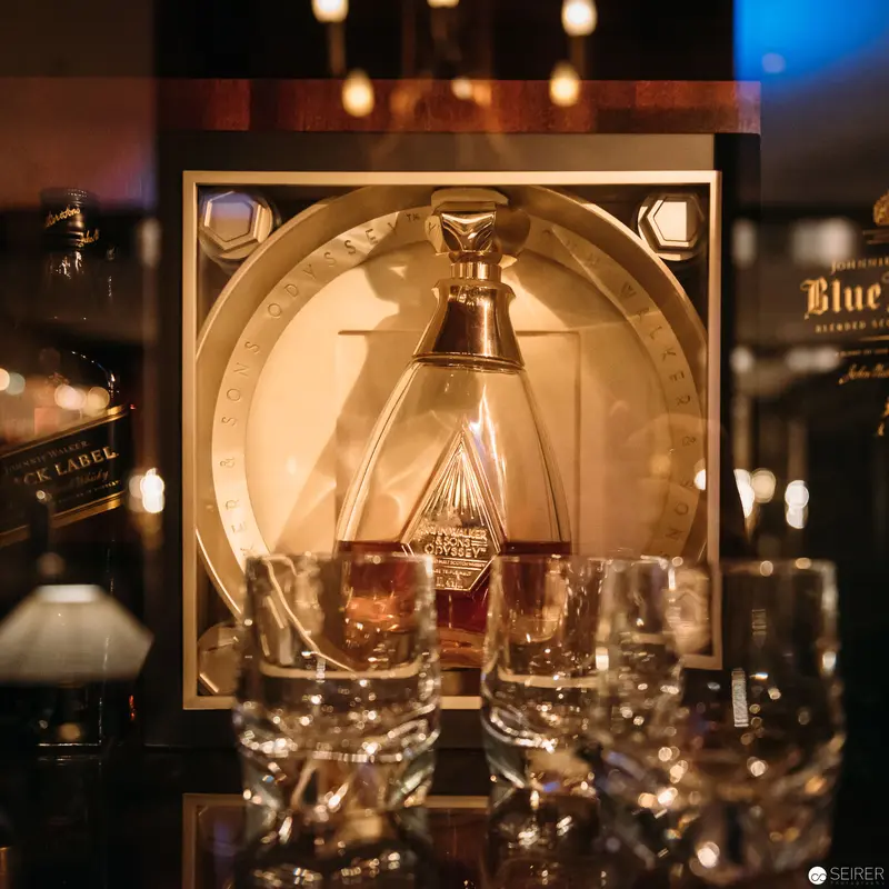 Illuminated Whisky Display with Crystal Glassware at Atmospheric Bar Setting