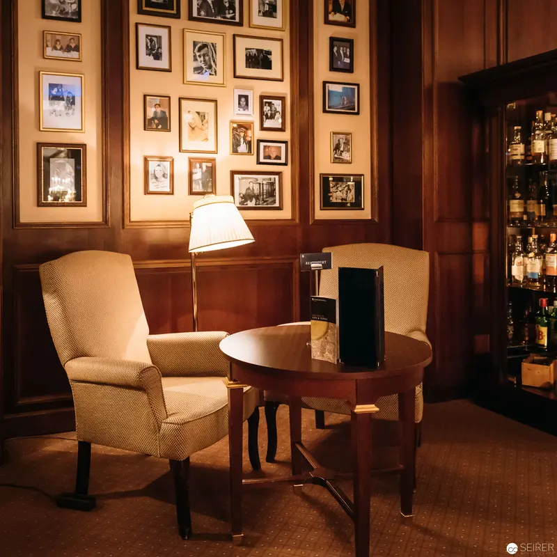 Intimate Bar Setting with Vintage Photographic Gallery in Warm Wood Tones