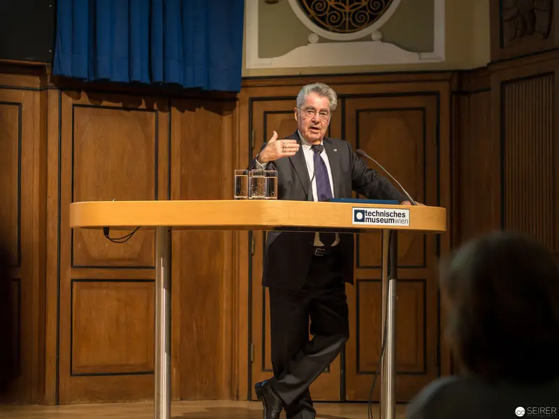 Scholarly Lecture at Technisches Museum: Presenter Gesturing at Podium
