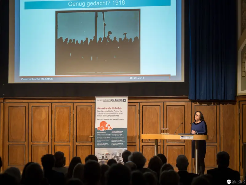 Academic Lecture on Historical Photograph of Silhouetted Crowd at Podium