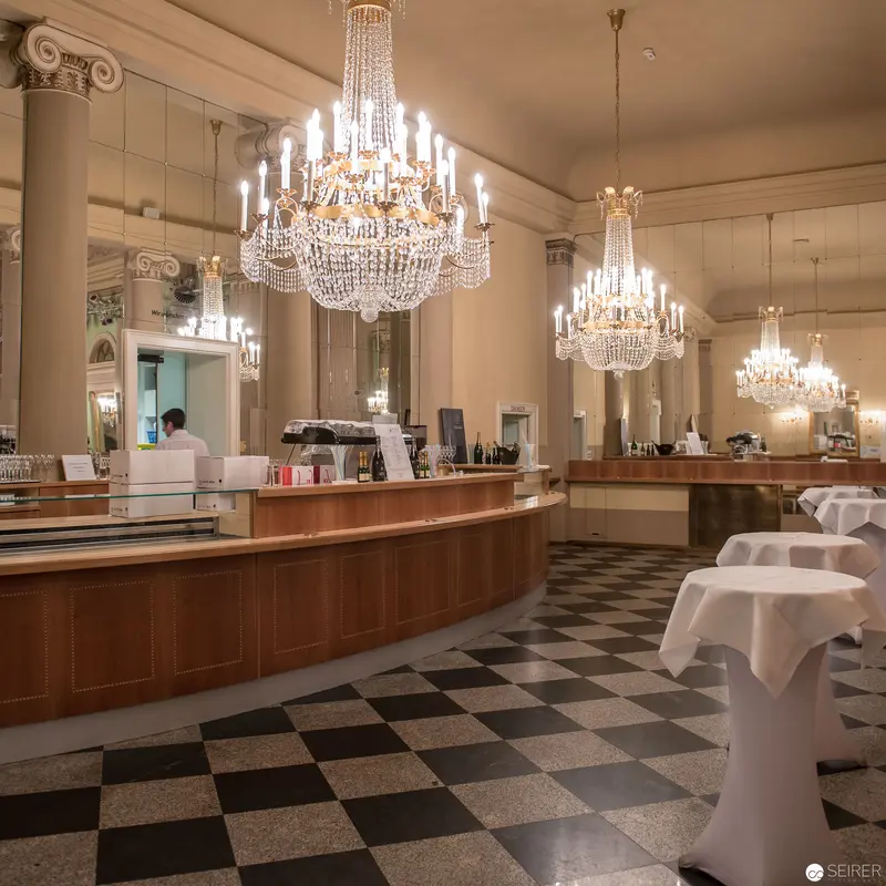 Elegant Café Interior with Crystal Chandeliers and Checkered Marble Floor