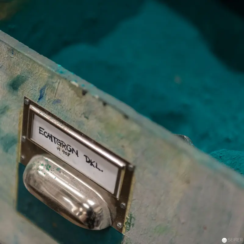 Vintage Drawer Pull with Esperson Label in Teal-Toned Architectural Setting