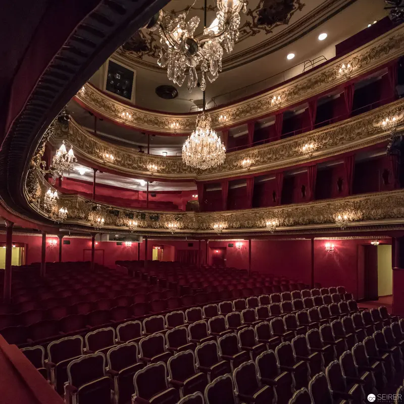 Ornate 19th-Century Opera House Interior with Crystal Chandeliers and Red Velvet Seating
