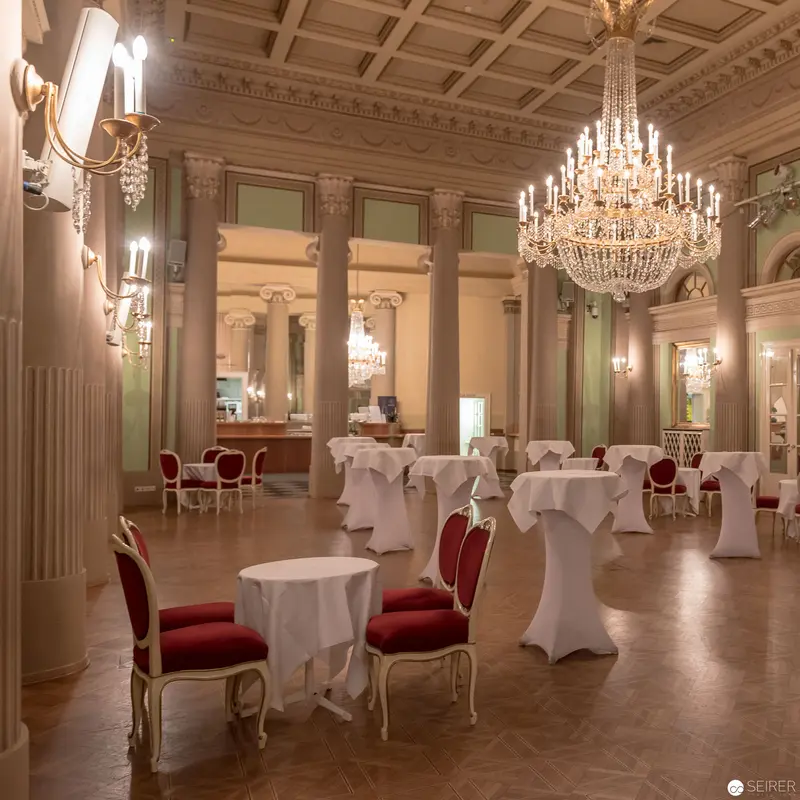 Elegant Ballroom Interior with Crystal Chandeliers and White-Draped Tables