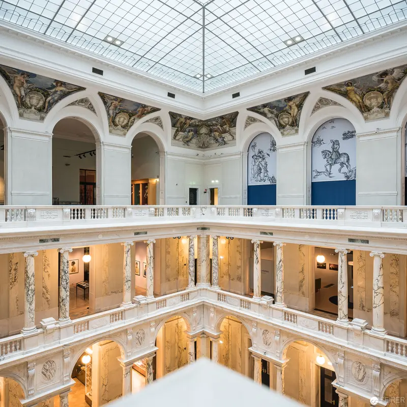 Neoclassical Interior with Luminous Glass Ceiling and Ornate Architectural Detailing