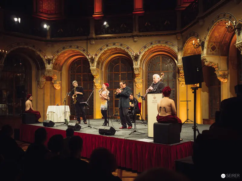 Musical Performance in Ornate Architectural Setting with Jazz Ensemble and Saxophonist